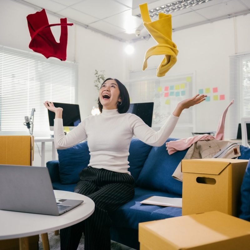 excited-businesswoman-throwing-clothes-in-the-air-after-successful-online-business-deal.jpg